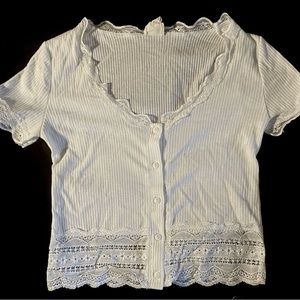 Cropped white top with lace pattern edges